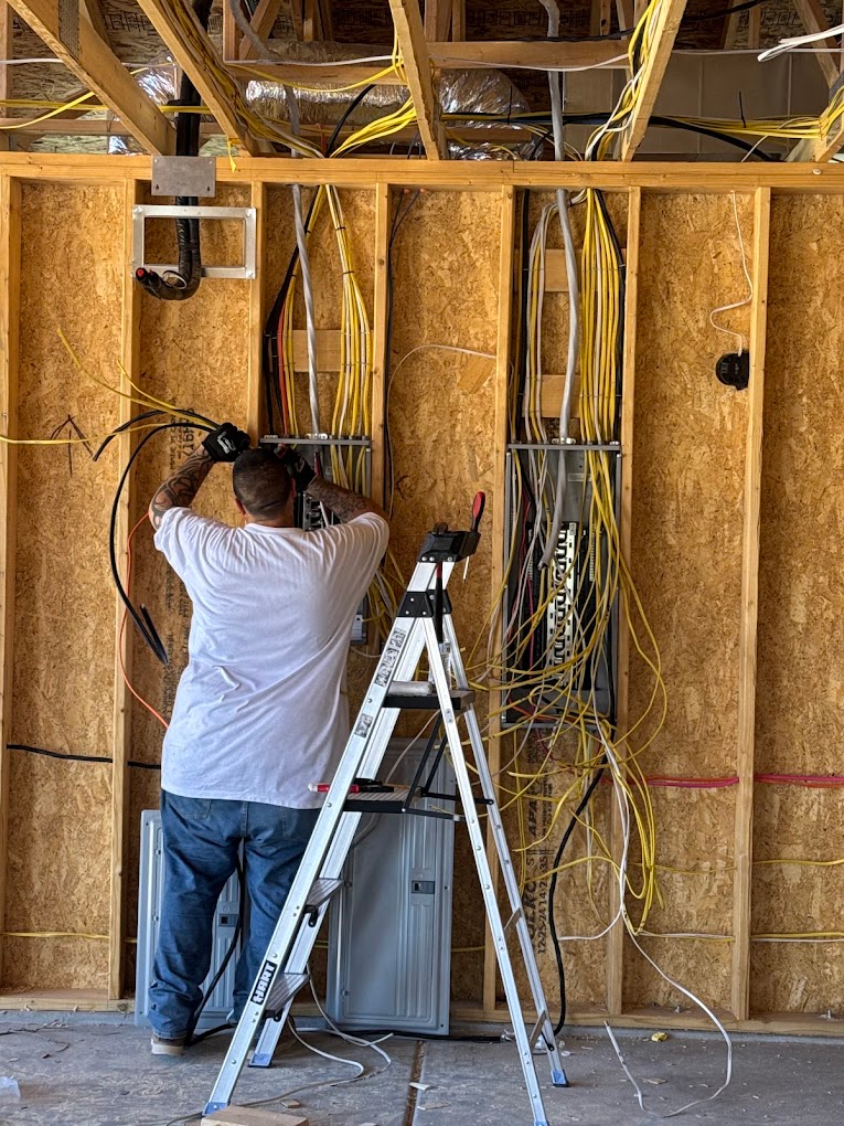 Elite Electrical technician wiring subpanels in a new construction build
