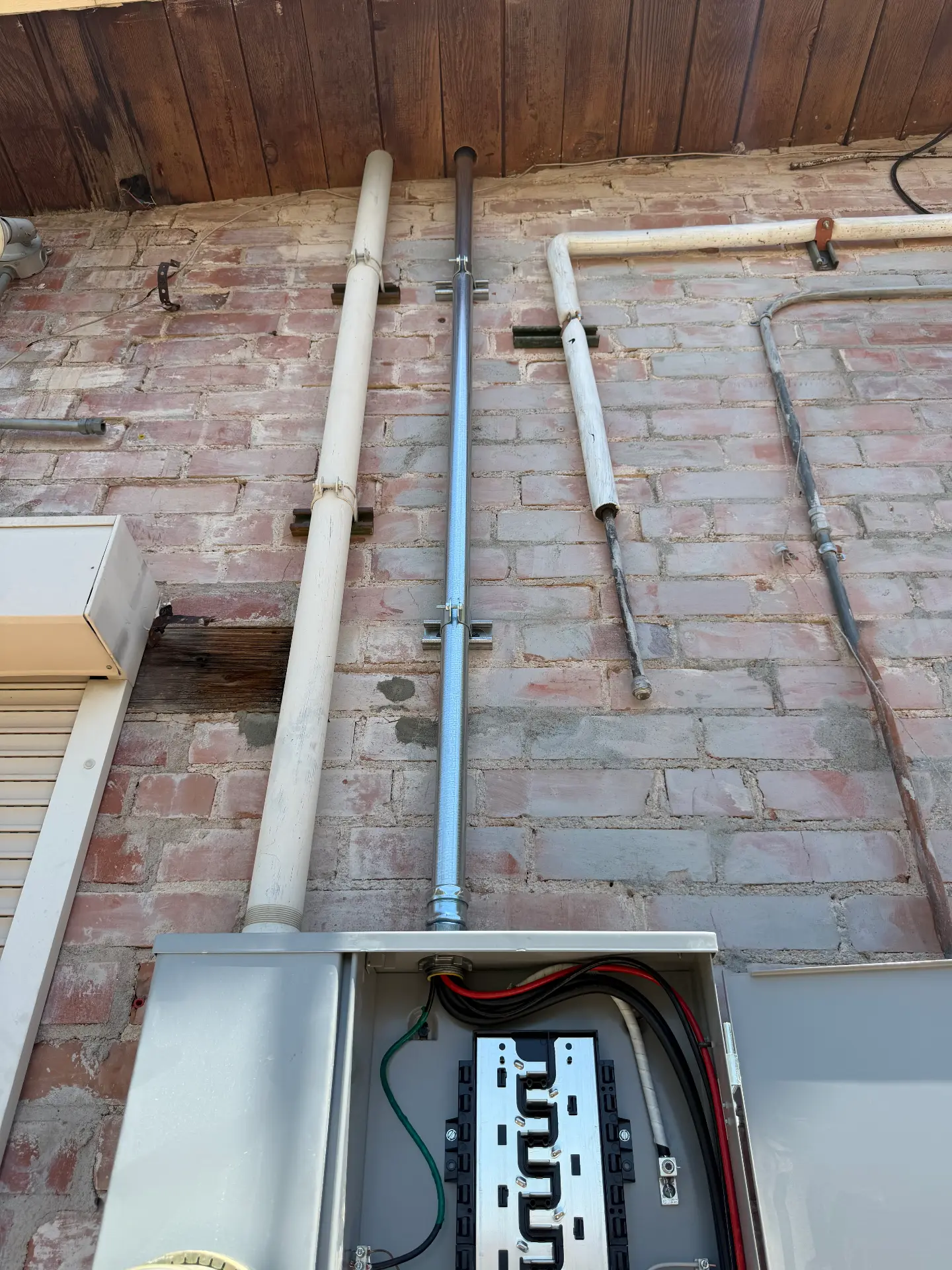 Service riser and panel replacement on a historic brick building